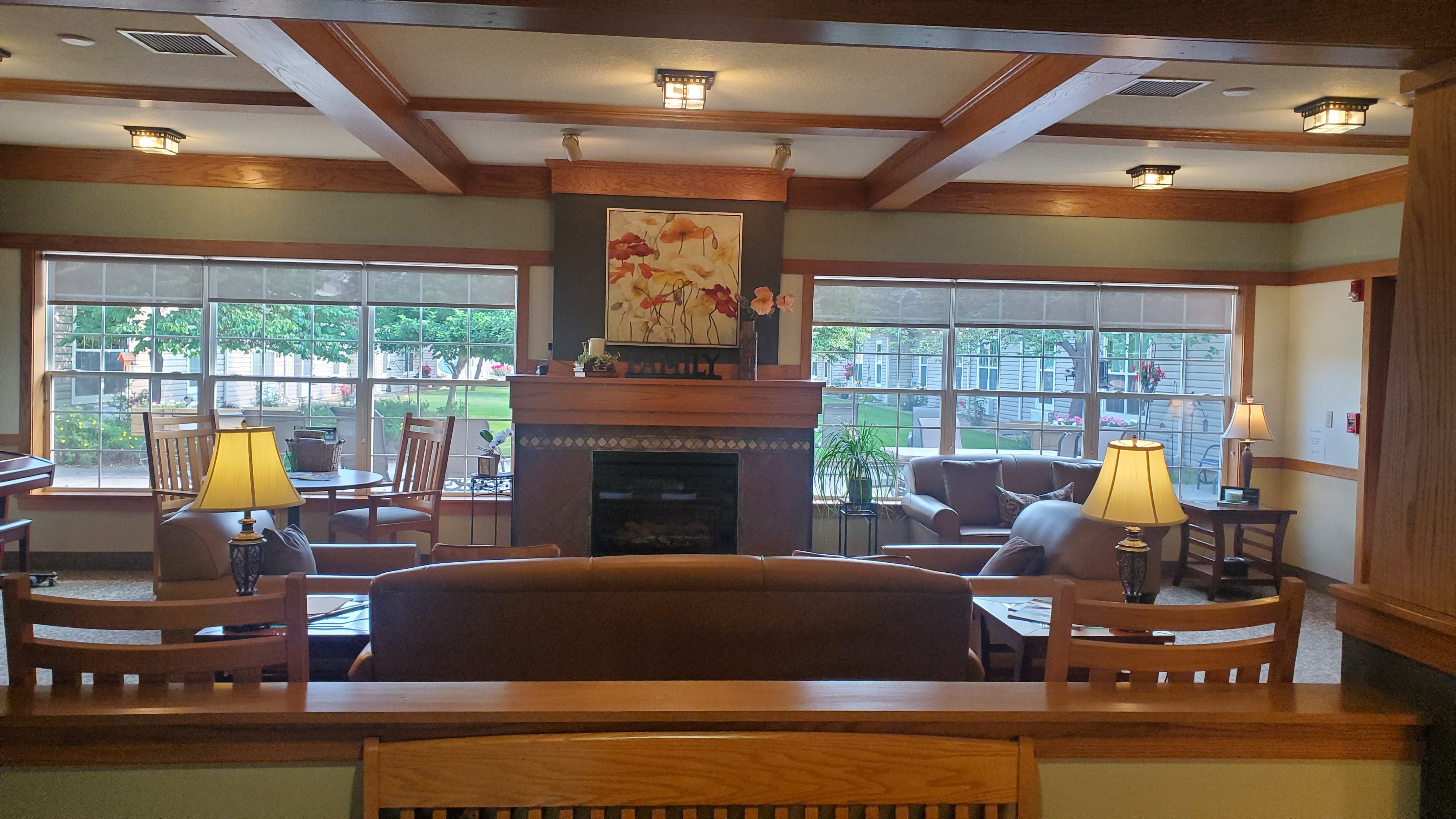 A living room with a fireplace at Windsor Manor Vinton, Vinton, IA